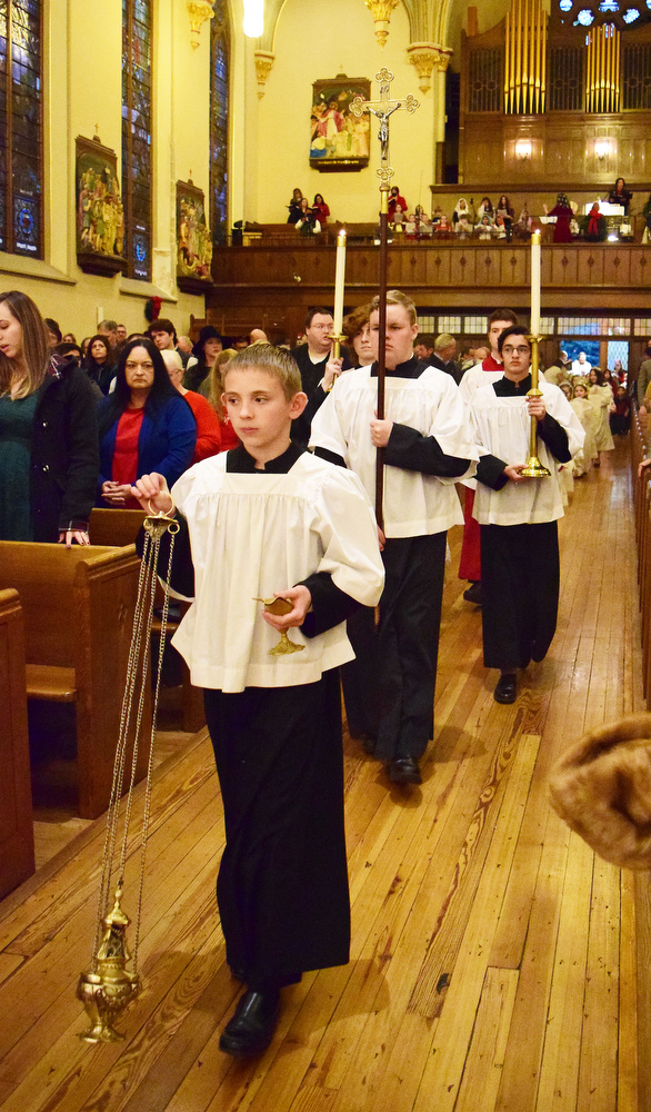 Staff Photo by Robin Rudd / The altar servers lead the procession into the church. The Vigil Mass of Christmas was celebrated at the Basilica of Saints Peter and Paul on December 24, 2021.