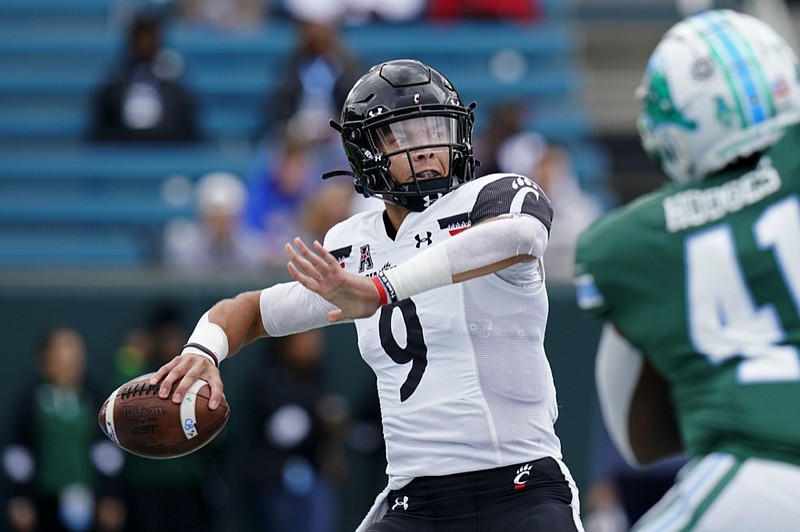 FILE - Cincinnati quarterback Desmond Ridder (9) passes during the first half of an NCAA college football game against Tulane in New Orleans, Saturday, Oct. 30, 2021. (AP Photo/Gerald Herbert, FIle)



