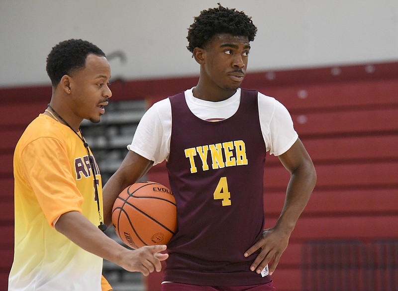 Staff photo by Matt Hamilton / Tyner boys' basketball coach E'Jay Ward talks to junior guard Nehemiah Bloodsaw during practice Wednesday. Ward said Bloodsaw is respected by his teammates and throughout the school for the effort he gives whenever he plays.