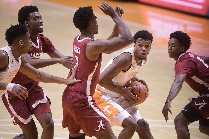 Knoxville News Sentinel photo by Caitie McMekin via AP / Tennessee guard Josiah-Jordan James is swarmed by Alabama defenders on Jan. 2 at Thompson-Boling Arena. Alabama won 71-63 that night in Knoxville and swept the season series between SEC rivals with a 73-68 victory on March 13 in Tuscaloosa. Alabama will visit Tennessee on Wednesday as part of opening night for SEC men's basketball this season.