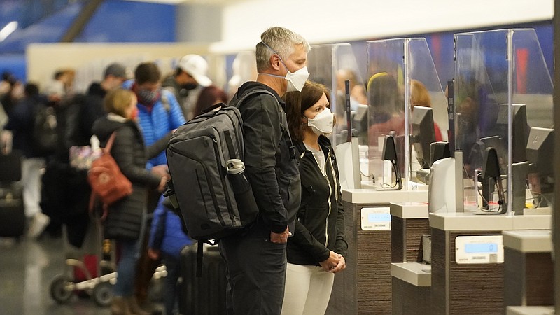 Photo by Rick Bowmer of The Associated Press / Holiday travelers stand at the Delta Air Lines ticketing line at Salt Lake City International Airport on Friday, Dec. 24, 2021, in Salt Lake City.