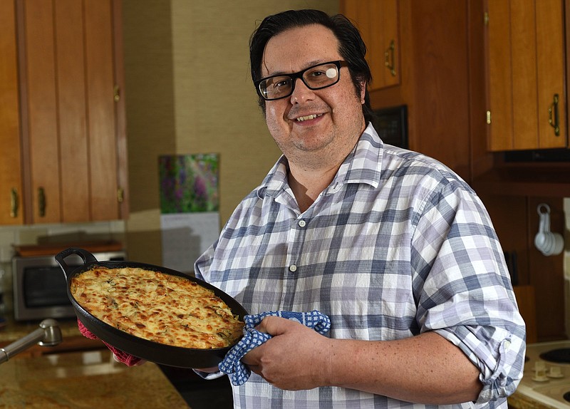 Staff Photo by Matt Hamilton / Chef Blackwell Smith with a potato and wild rice casserole with a bechamel sauce at his home on Lookout Mountain.