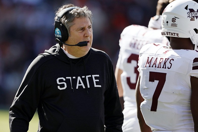FILE - Mississippi State head coach Mike Leach talks with players during a timeout in the first half of an NCAA college football game against Auburn, Saturday, Nov. 13, 2021, in Auburn, Ala. (AP Photo/Butch Dill, File)