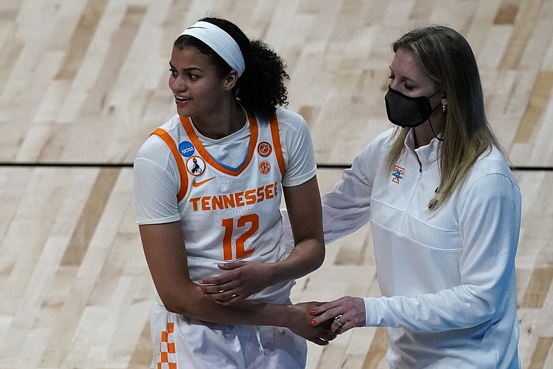 Tennessee head coach Kellie Harper talks to guard Rae Burrell (12) during the second half of a college basketball game against Michigan in the second round of the women's NCAA tournament at the Alamodome in San Antonio, Tuesday, March 23, 2021. (AP Photo/Charlie Riedel)