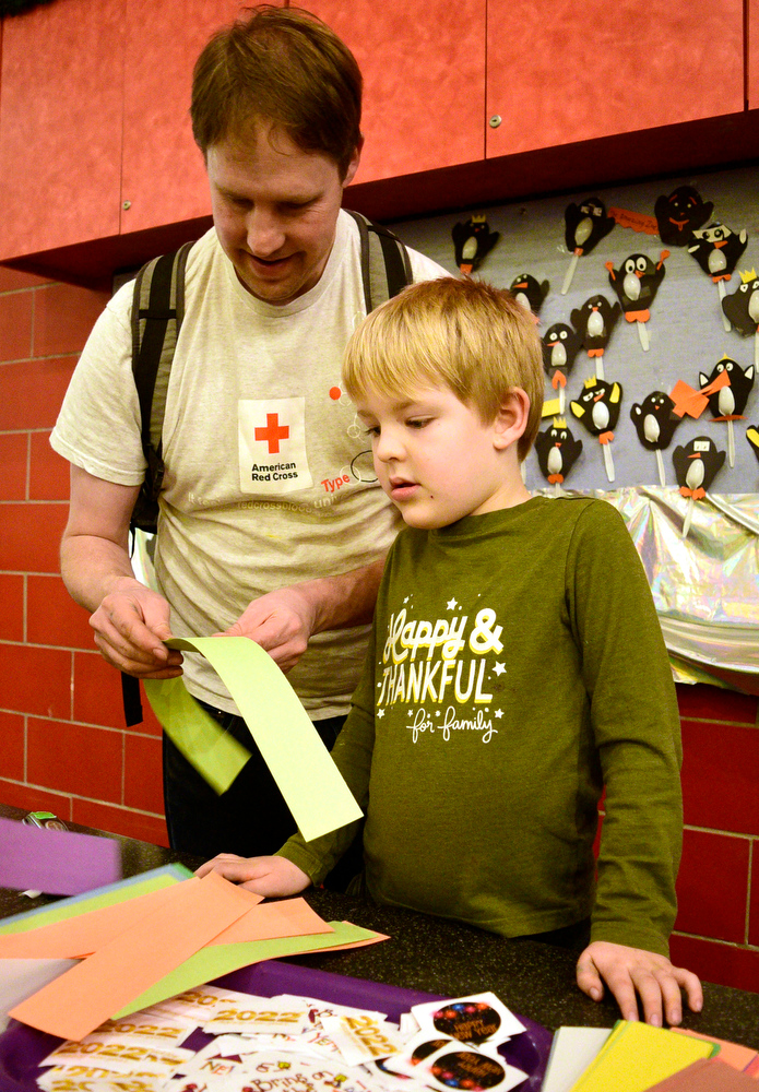 Staff Photo by Robin Rudd / Scott Pairan helps son, Noah, build a New Years Hat. The New Year was celebrated during the "Cheers for the New Year" event at the Creative Discovery Museum on December 30, 2021.