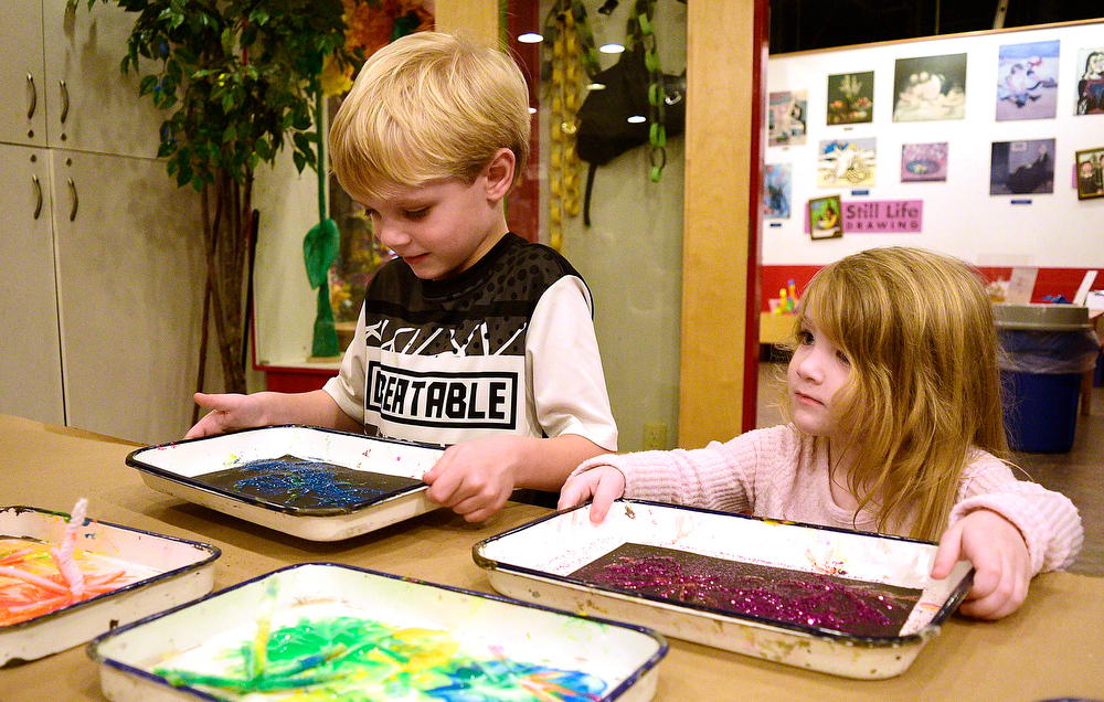 Staff Photo by Robin Rudd / From left, Sawyer and Amelia Bunn work on their creations at the Glitter Fireworks craft station. The New Year was celebrated during the "Cheers for the New Year" event at the Creative Discovery Museum on December 30, 2021.