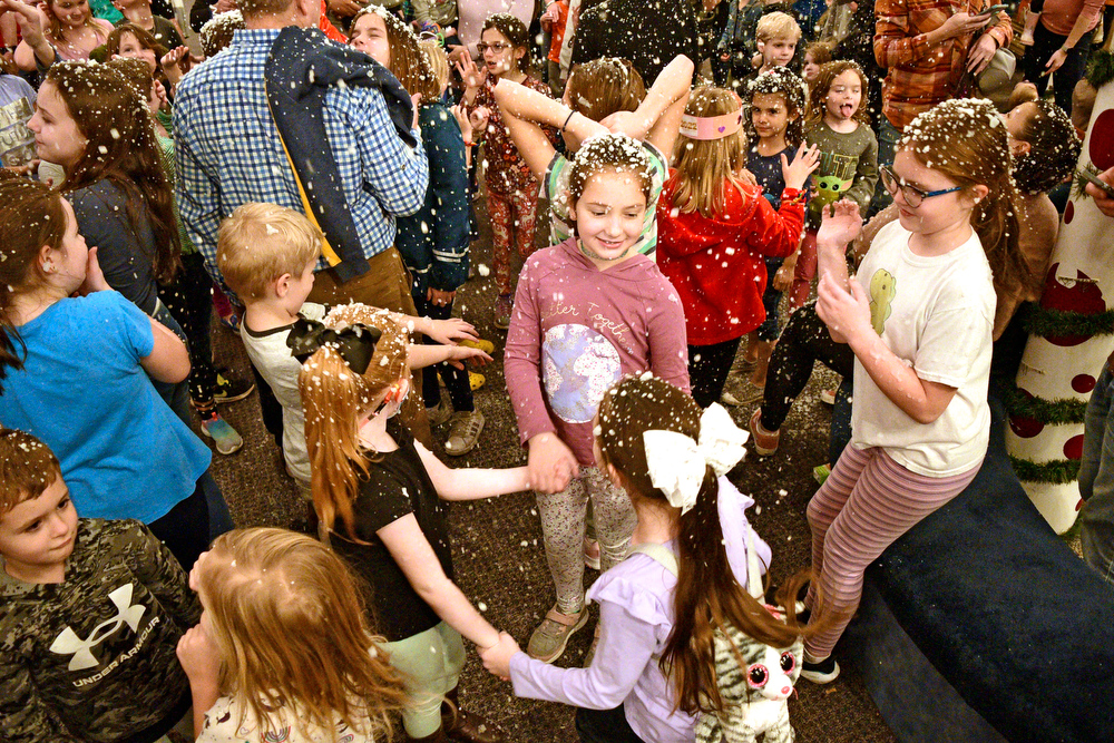 Staff Photo by Robin Rudd / Children dance as imitation snow falls on them, before the balloon drop. The New Year was celebrated during the "Cheers for the New Year" event at the Creative Discovery Museum on December 30, 2021.