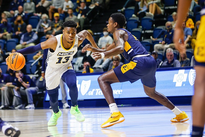Staff photo by Troy Stolt / UTC's Malachi Smith drives to the basket during Thursday night's SoCon opener against East Tennessee State at McKenzie Arena.