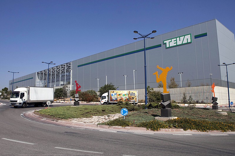 FILE - Trucks drive in front of Teva Pharmaceutical Logistic Center in the town of Shoam, Israel, Oct. 16, 2013. A jury held Teva Pharmaceuticals responsible, Thursday, Dec. 30, 2021, for contributing to the opioid crisis, delivering a verdict in a sweeping lawsuit filed by New York state, the state attorney general said. (AP Photo/Dan Balilty, File)