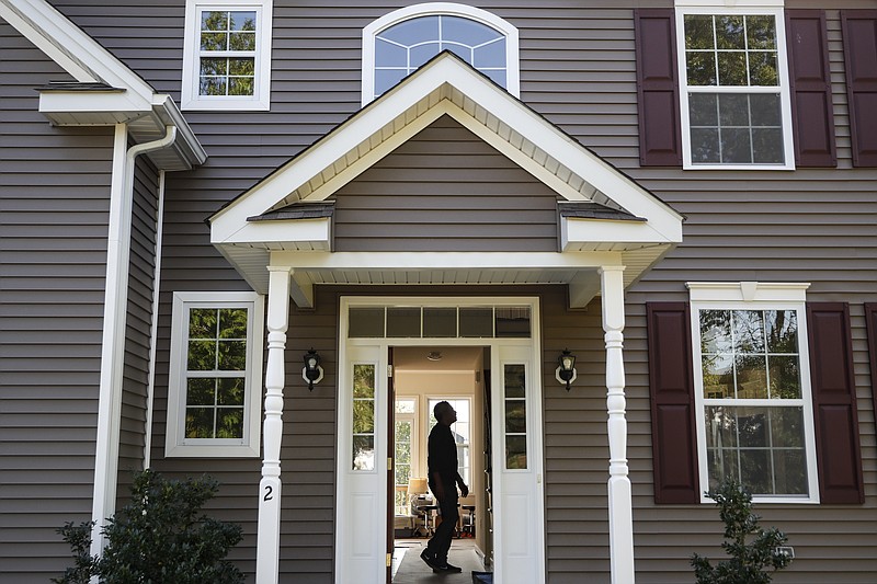 FILE - In this July 21, 2020, file photo, a homeowner tours their new home, in Washingtonville, N.Y. In addition to the new year bringing confetti and a fresh calendar, it's a time to set big money goals for the next 12 months. That might mean finally paying off debt, buying a house or taking a long-delayed vacation. (AP Photo/John Minchillo, File)