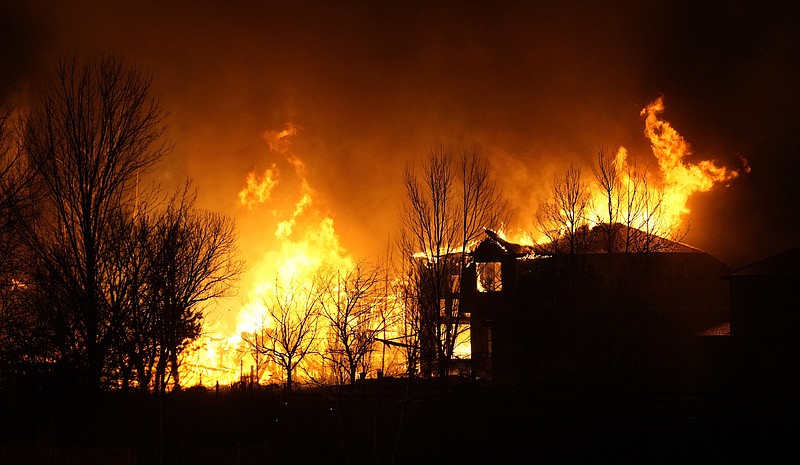 Homes burn as wildfires rip through a development near Rock Creek Village Thursday, Dec. 30, 2021, in Superior, Colo. Homes surrounding the Flatiron Crossing mall were being evacuated as wildfires raced through the grasslands as high winds raked the intermountain West. / AP Photo by David Zalubowski