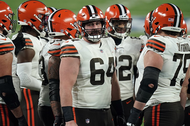 FILE - Cleveland Browns center JC Tretter (64) talks to teammates during the first half of an NFL football game against the New York Giants on Dec. 20, 2020, in East Rutherford, N.J. Tretter, the NFL Players Association president who has been pushing for daily COVID-19 testing all season, said he tested positive for the virus on Thursday, Dec. 23, 2021.  (AP Photo/Seth Wenig, File)