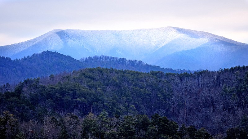 Staff photo by Robin Rudd / The crest of 4,222-foot Big Frog Moutain, frosted with snow, rises above the Ocoee River in the Cherokee National Forest in Polk County, Tennessee, on Jan. 20, 2020. Hot or cold, summer or winter, it's always a good time to be outside if you enjoy the outdoors, writes columnist Larry Case.