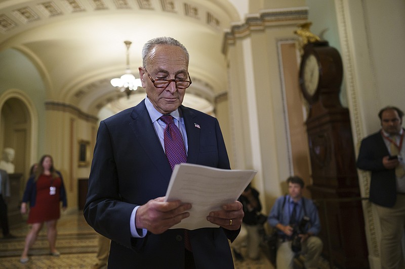 Photo by J. Scott Applewhite of The Associated Press / Senate Majority Leader Chuck Schumer, D-N.Y., looks over his notes as he talks to reporters at the Capitol in Washington on Tuesday, July 20, 2021.