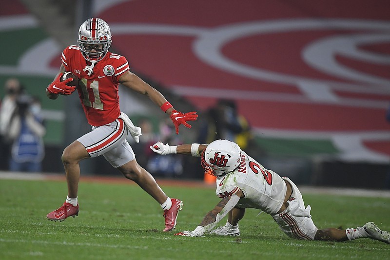 AP photo by John McCoy / Ohio State wide receiver Jaxon Smith-Njigba runs past Utah cornerback Kenzel Lawler during the Rose Bowl on Saturday in Pasadena, Calif. Smith-Njigba had 15 catches for 347 yards and three touchdowns to help the Buckeyes rally from 14 points down to win 48-45.