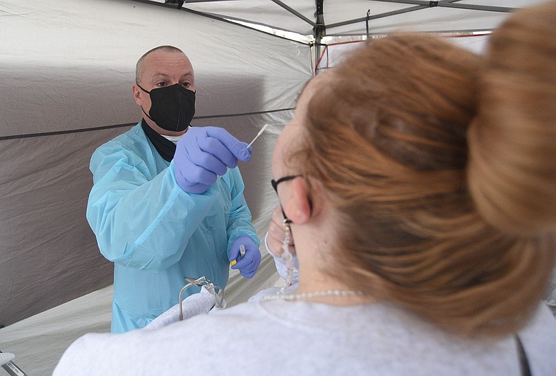 Staff Photo by Matt Hamilton / Greg Roberts takes a nasal swab for a COVID-19 test at a temporary community testing site set up by Athena Esoterix on Signal Mountain Road on Thursday, Jan. 6, 2022.