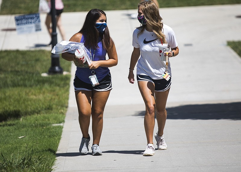 Staff photo by Troy Stolt / Sophomore nursing major Savannah Wooten walks to class with Hannah Nelson, a sophomore early education major, on campus at UTC on Monday, Aug. 17, 2020, in Chattanooga, Tenn.