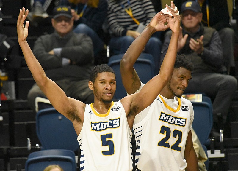 Staff photo by Matt Hamilton / UTC's Darius Banks (5) and Silvio De Sousa (22) celebrate on the sideline after the Mocs scored during Saturday's SoCon win against The Citadel at McKenzie Arena.
