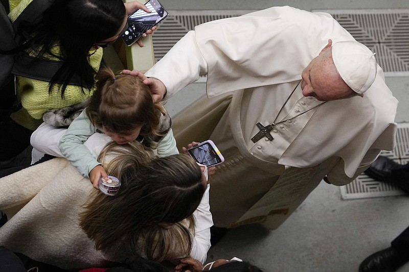 Photo by Alessandra Tarantino of The Associated Press / Pope Francis comforts a child during his weekly general audience in the Paul VI Hall, at the Vatican on Wednesday, Jan. 5, 2022.