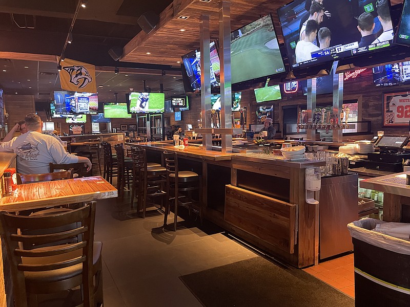Photo by Anne Braly / The main bar at Miller's Ale House includes bar and table seating, plus multiple televisions tuned to sports channels.