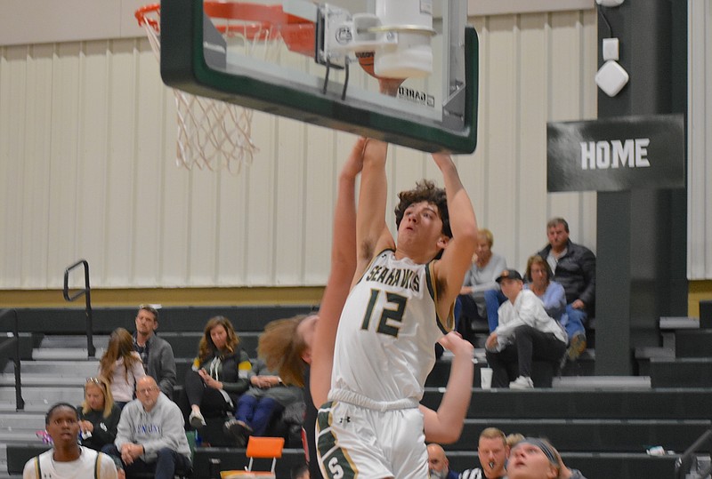 Staff photo by Patrick MacCoon / Silverdale Baptist sophomore Brett Wright rises on the left baseline for a slam dunk in Monday's home win over Collegedale Academy.