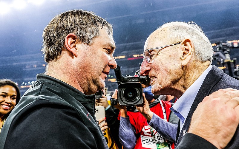 University of Georgia photo / Georgia's two head football coaches with Associated Press national championships, Kirby Smart and Vince Dooley, talk after the Bulldogs' 33-18 win over Alabama in Monday night's title game in Indianapolis.