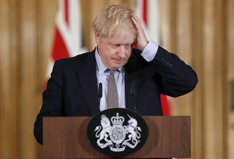 FILE - Britain's Prime Minister Boris Johnson reacts during a press conference at Downing Street on the government's coronavirus action plan in London Tuesday, March 3, 2020. (AP Photo/Frank Augstein, File)