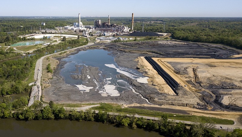 FILE - In this May 1, 2018, file photo, the Richmond, Va., city skyline is seen in the horizon behind the coal ash ponds along the James River near Dominion Energy's Chesterfield Power Station in Chester, Va. (AP Photo/Steve Helber, File)


