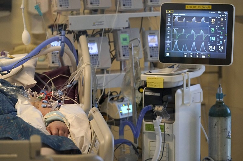 FILE - An unidentified COVID-19 patient is attached to life-support systems in the COVID-19 Intensive Care Unit at Dartmouth-Hitchcock Medical Center, in Lebanon, N.H., Jan. 3, 2022. (AP Photo/Steven Senne, File)


