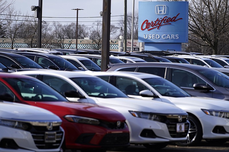 A dealership sign is seen outside of a Honda certified used car dealership in Schaumburg, Ill., Thursday, Dec. 16, 2021. Prices paid by U.S. consumers jumped in December 2021 compared to a year earlier, the latest evidence that rising costs for food, gas, rent and other necessities are heightening the financial pressures on America's households. (AP Photo/Nam Y. Huh)