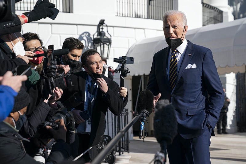 President Joe Biden talks to reporters before boarding Marine One on the South Lawn of the White House, Tuesday, Jan. 11, 2022, in Washington. The Biden administration is increasing federal support for COVID-19 testing for schools in a bid to keep them open amid the omicron surge. The White House said Wednesday the administration is making a dedicated stream of 5 million rapid tests and 5 million lab-based PCR tests available to schools starting this month. (AP Photo/Evan Vucci)