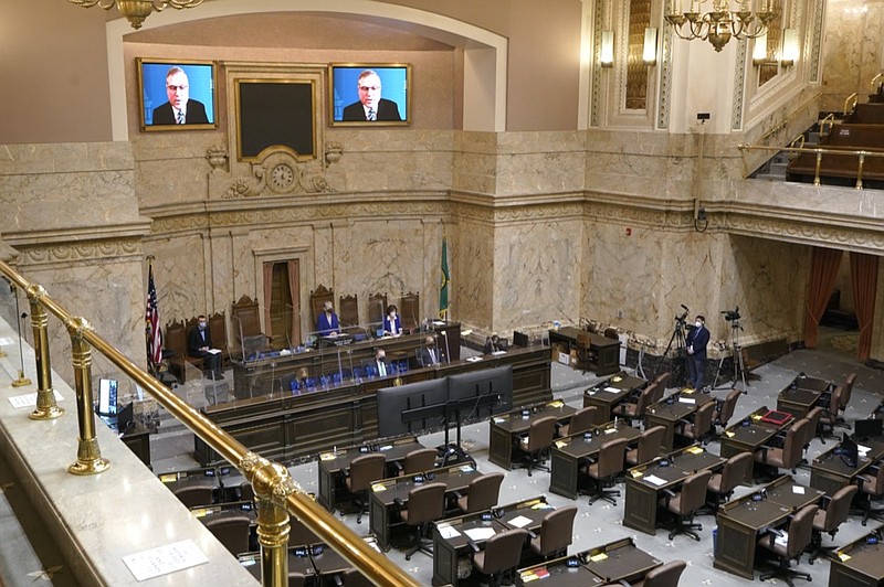 FILE - House Republican Leader J.T. Wilcox, R-Yelm, is displayed on video screens as he speaks remotely following opening remarks from House Speaker Laurie Jinkins, D-Tacoma, during the opening session of the Washington state House, Jan. 10, 2022, at the Capitol in Olympia, Wash. (AP Photo/Ted S. Warren, File)


