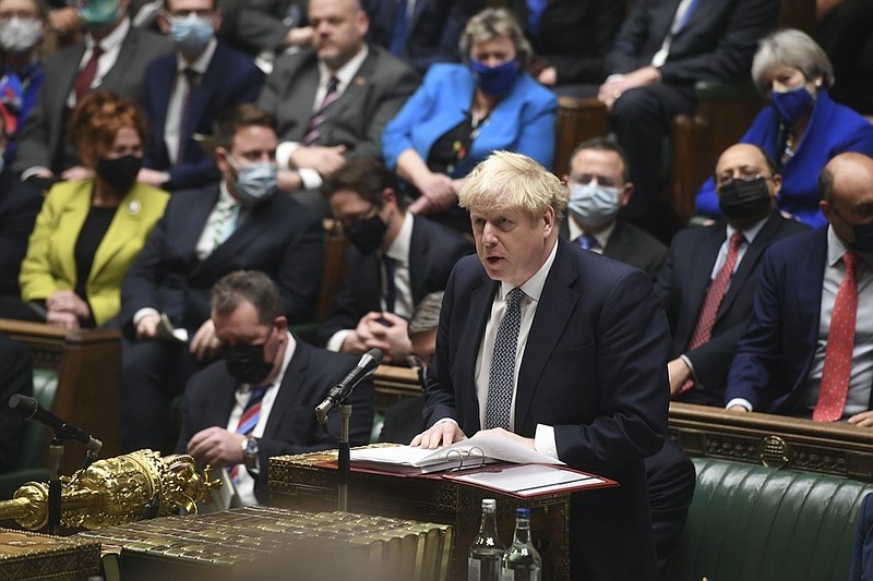 In this photo provided by UK Parliament, Britain's Prime Minister Boris Johnson speaks during Prime Minister's Questions in the House of Commons, in London, Wednesday, Jan. 12, 2022. Johnson has apologized for attending a garden party during Britain's first coronavirus lockdown, but brushed aside opposition demands that he resign for breaching the rules his own government had imposed on the nation. The apology Wednesday stopped short of admitting wrongdoing. It was Johnson's attempt to assuage a tide of anger from the public and politicians after repeated accusations he and his staff flouted pandemic restrictions by socializing when it was banned. (UK Parliament/Jessica Taylor via AP)
