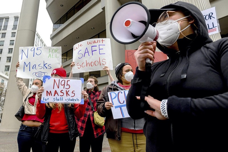 FILE - Teachers protest for stronger COVID-19 safety protocols outside Oakland Unified School District headquarters on Jan. 7, 2022, in Oakland, Calif. (AP Photo/Noah Berger, File)


