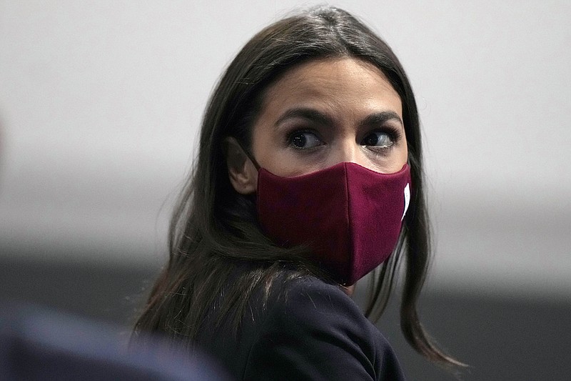 File photo by Alastair Grant of The Associated Press / U.S. Rep. Alexandria Ocasio-Cortez, shown here at the COP26 U.N. Climate Summit in Glasgow, Scotland, on Wednesday, Nov. 10, 2021, recently tested positive for COVID.