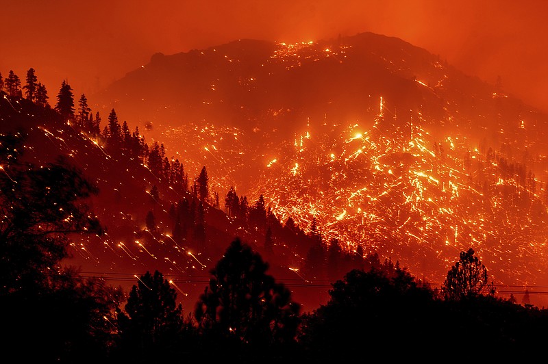 AP file photo by Noah Berger / In this Aug. 17, 2021, file photo, embers light up hillsides as the Dixie Fire burns near Milford in Lassen County, California. World leaders have been trying to do something about climate change for 29 years but in that time Earth has gotten much hotter and more dangerous.