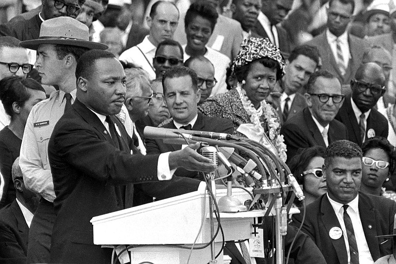 File photo from The Associated Press / The Rev. Dr. Martin Luther King Jr., delivers his "I Have a Dream" speech in Washington on Aug. 28, 1963, as National Park Service ranger Gordon "Gunny" Gundrum, left, stands beside King.