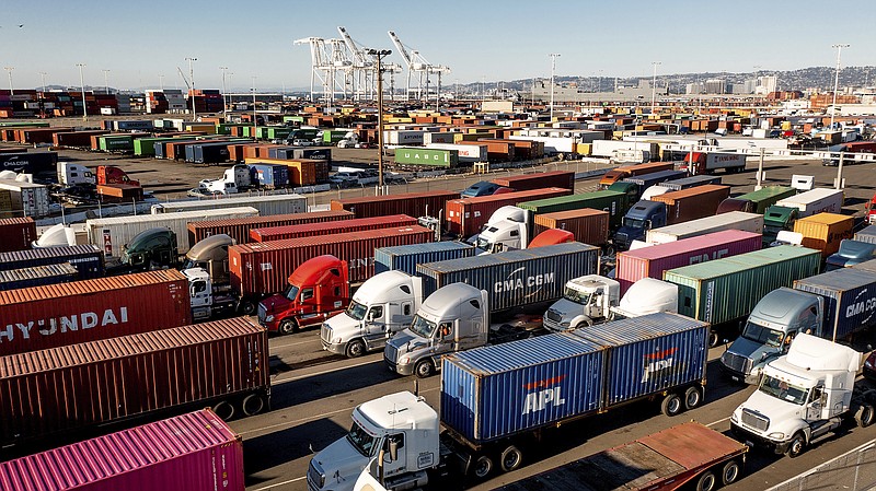 FILE - Trucks line up to enter a Port of Oakland shipping terminal on Wednesday, Nov. 10, 2021, in Oakland, Calif. The federal government is moving forward with a plan to let teenagers drive big rigs from state to state in a test program. Currently, truckers who cross state lines have to be at least 21 years old, but an apprenticeship program required by Congress to help ease supply chain backlogs would let 18-to-20-year-old truckers drive outside their home states. (AP Photo/Noah Berger, File)