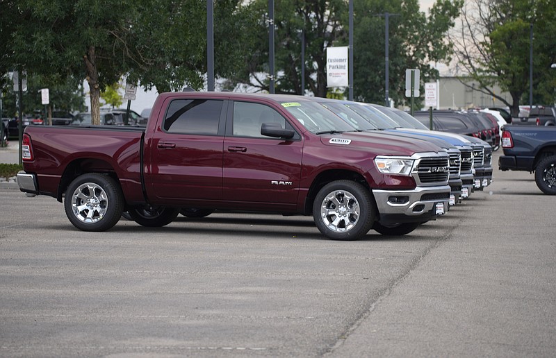 Only a handful of unsold 2021 Ram pickup trucks sit on the empty storage lot outside a Ram dealership on Sunday, Aug. 29, 2021, in Littleton, Colo. (AP Photo/David Zalubowski)