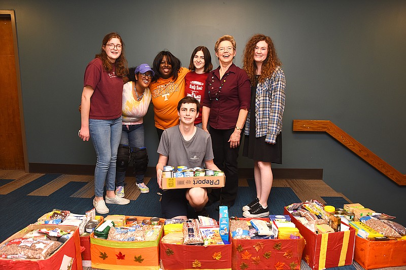 Some of those involved in the 2021 food drive were, from left, Abigail Bateman, Selena and Nakota Jude, Violet Decredico, ProfessorKatheryn Thompson and Madison Lewis. Kneeling is Andrew Wilson.