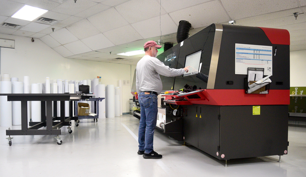 Staff Photo by Robin Rudd / Tim Moore works with one of Vincent's huge digital printers. Vincent Printing, formed in 1940, and located in East Chattanooga, is one of the country's biggest print shops of its type. New owner. Beau Wells talked with the newspaper on January 13, 2022.