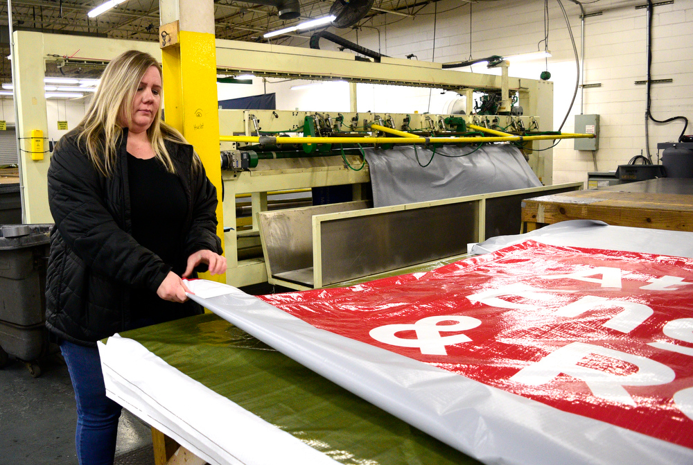 Staff Photo by Robin Rudd / Crew leader Valerie Van Velbhuizen folds a large ad. Vincent Printing, formed in 1940, and located in East Chattanooga, is one of the country's biggest print shops of its type. New owner. Beau Wells talked with the newspaper on January 13, 2022.
