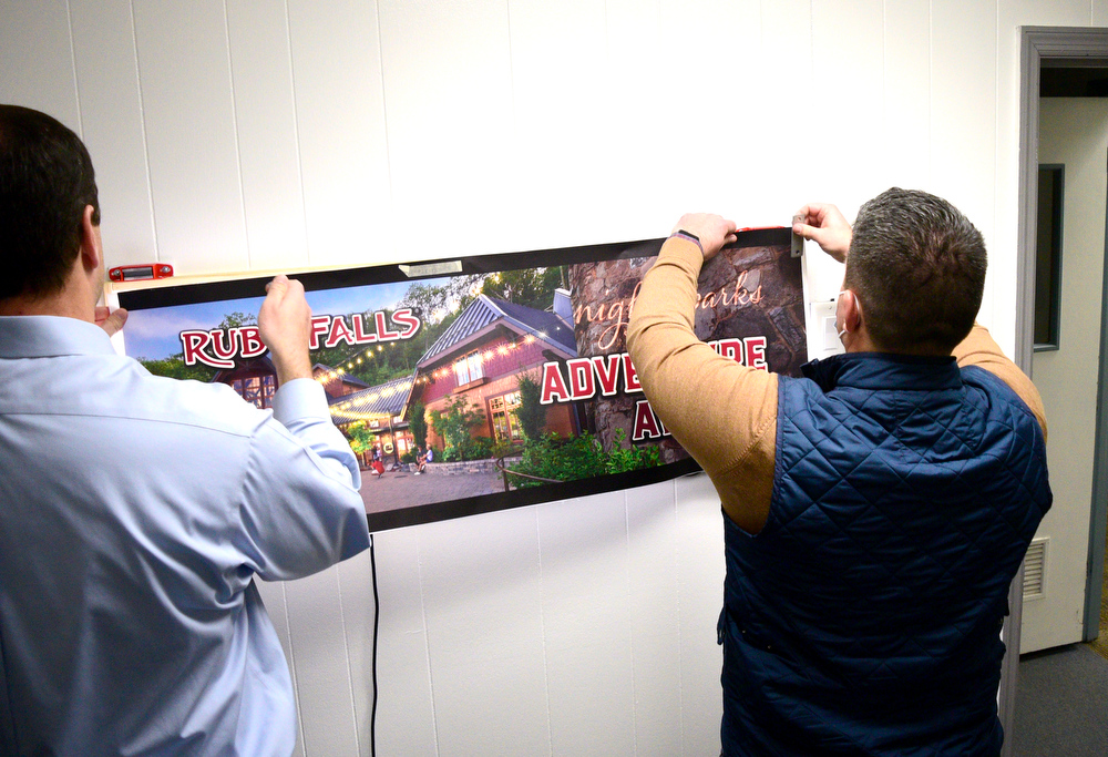 Staff Photo by Robin Rudd / From left Bo Freelend and Beau Wells prepare a demonstration of one of the company's billboards that feature backlighting to make the ad come alive at night. Vincent Printing, formed in 1940, and located in East Chattanooga, is one of the country's biggest print shops of its type. New owner. Beau Wells talked with the newspaper on January 13, 2022.