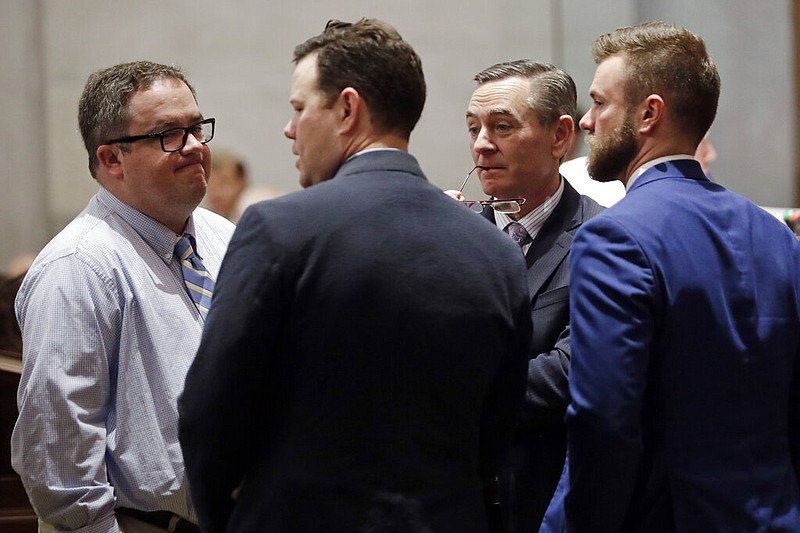 Then-House Speaker Glen Casada, R-Franklin, second from right, talks with Rep. Matthew Hill, R-Jonesborough, left; Rep. Michael Curcio, R-Dickson, second from left; and Cade Cothren, then chief of staff for Speaker Casada, right; during a Senate session Thursday, May 2, 2019, in Nashville, Tenn. (AP Photo/Mark Humphrey)