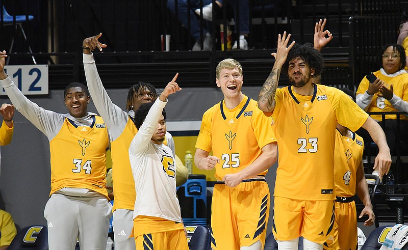 Staff photo by Matt Hamilton / UTC players cheer after a teammate scored during Saturday's SoCon men's basketball showdown against Furman at McKenzie Arena.