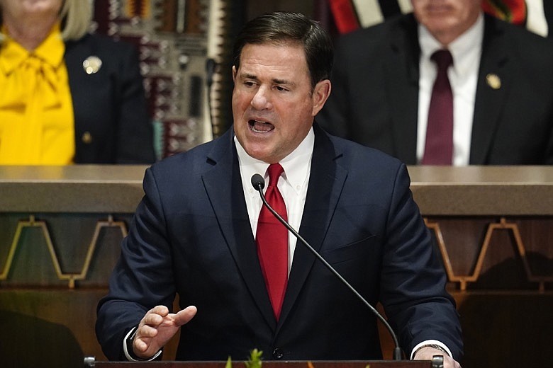 In this Jan. 10, 2022, photo, Arizona Republican Gov. Doug Ducey gives his state of the state address at the Arizona Capitol, in Phoenix. Former President Donald Trump is stepping up his election-year effort to dominate the Republican Party with a Saturday rally in Arizona in which he plans to castigate anyone who dares to question his lie that the 2020 presidential election was stolen, likely including Ducey. (AP Photo/Ross D. Franklin)