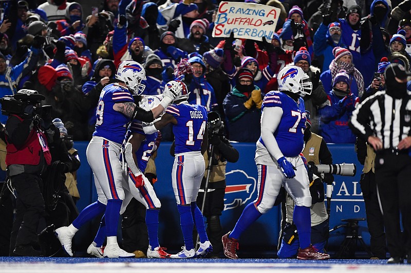 AP photo by Adrian Kraus / Buffalo Bills running back Devin Singletary, second from left, celebrates with teammates after scoring during the first half of Saturday night's AFC wild-card playoff game against the rival New England Patriots in Orchard Park, N.Y.