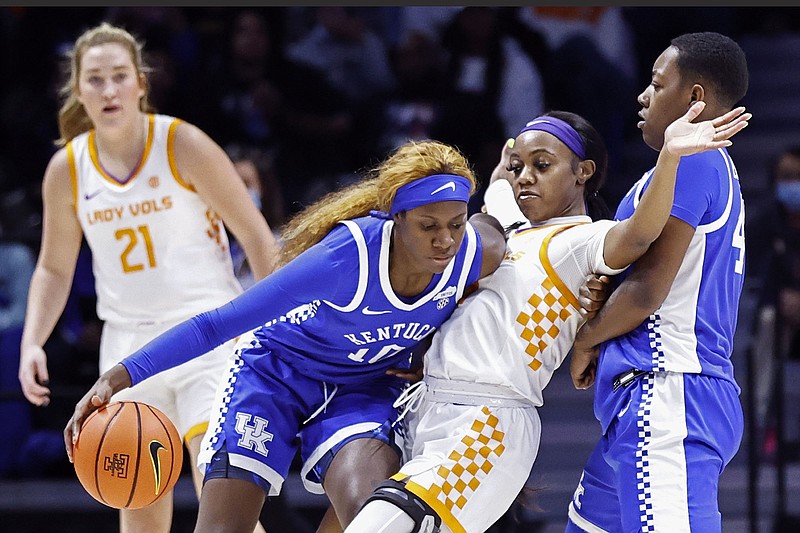 AP photo by Wade Payne / Kentucky guard Rhyne Howard, left, collides with Tennessee guard Jordan Walker while driving around a screen by Dre'una Edwards during Sunday's SEC basketball showdown in Knoxville. Howard, a former Bradley Central High School standout, scored a game-high 24 points, but No. 5 Tennessee beat the No. 19 Wildcats 84-58.