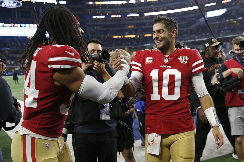 AP photo by Roger Steinman / San Francisco 49ers middle linebacker Fred Warner, left, celebrates with quarterback Jimmy Garoppolo after Sunday's NFC wild-card playoff win against the Dallas Cowboys in Arlington, Texas.