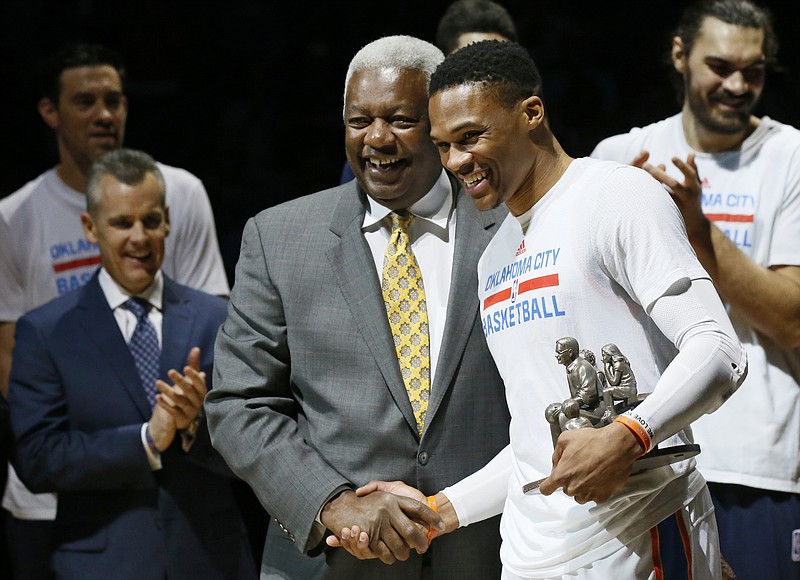 AP photo by Sue Ogrocki / Oklahoma City Thunder guard Russell Westbrook, right, is congratulated by Oscar Robertson, left, on his single-season triple-double record before a home game against the Denver Nuggets on April 12, 2017.